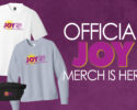 Banner advertising official JOY merch with white and light-blue shirts and a black fanny pack on a purple background, including the Joy logo and sun emblem.